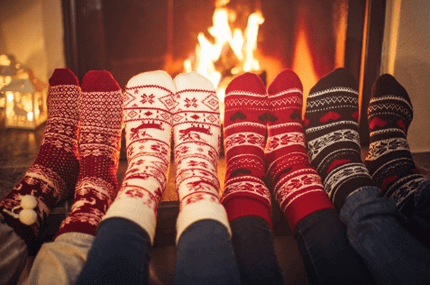 feet with socks on in front of fire
